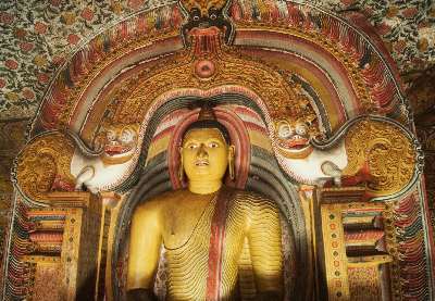 Buddha protected by a makara torana, in Cave 3 of Dambulla Rock temple , in Dambulla (Sri Lanka, Cultural Triangle)