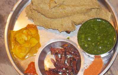 Nepali/Thakali Food: Thali with buckwheat dumpling (diro), dried meat (sukuti), taro vegetable and spice powder