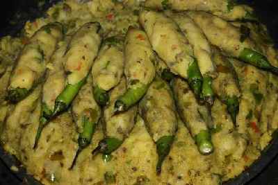 Rajasthani/Indian Food: Preparing Chili Pakora (Mirch Pakora): Coating Chilies with spiced potato mash