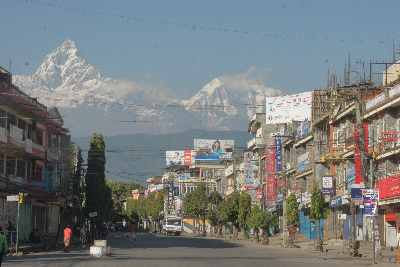 Streetview in Pokhara with Machhapuchare and Anapurna mountains, Nepal