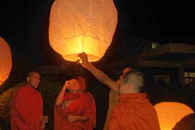 Theravada Buddhist Monk releasing air-floating paper lantern in Raj-Bana Vihara Monastery, Rangamati (Chittagong Hill Tracts, Bangladesh)